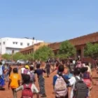 Un homme distribue 5 000 F à des enfants devant les écoles